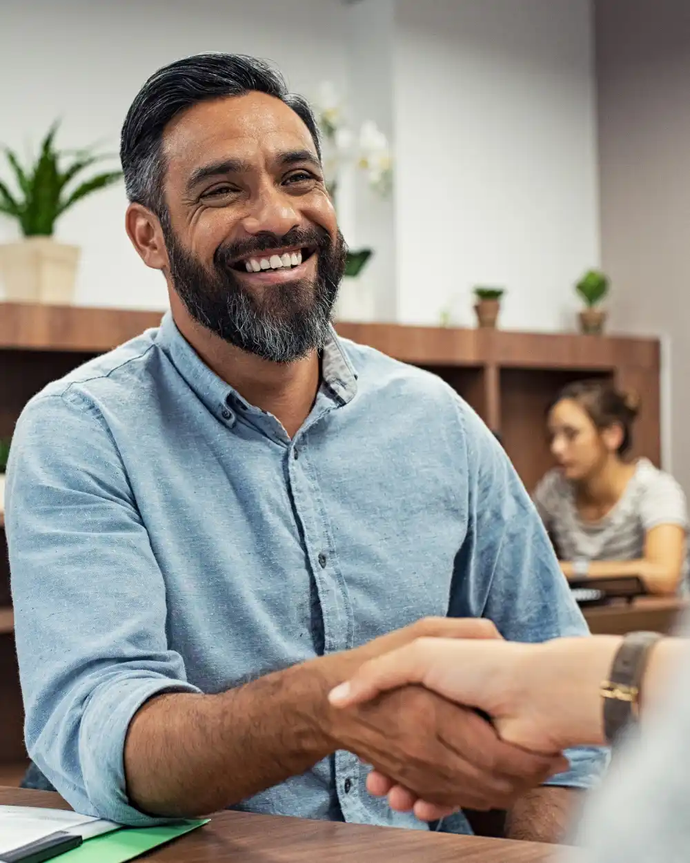 Man shaking hands in an office.